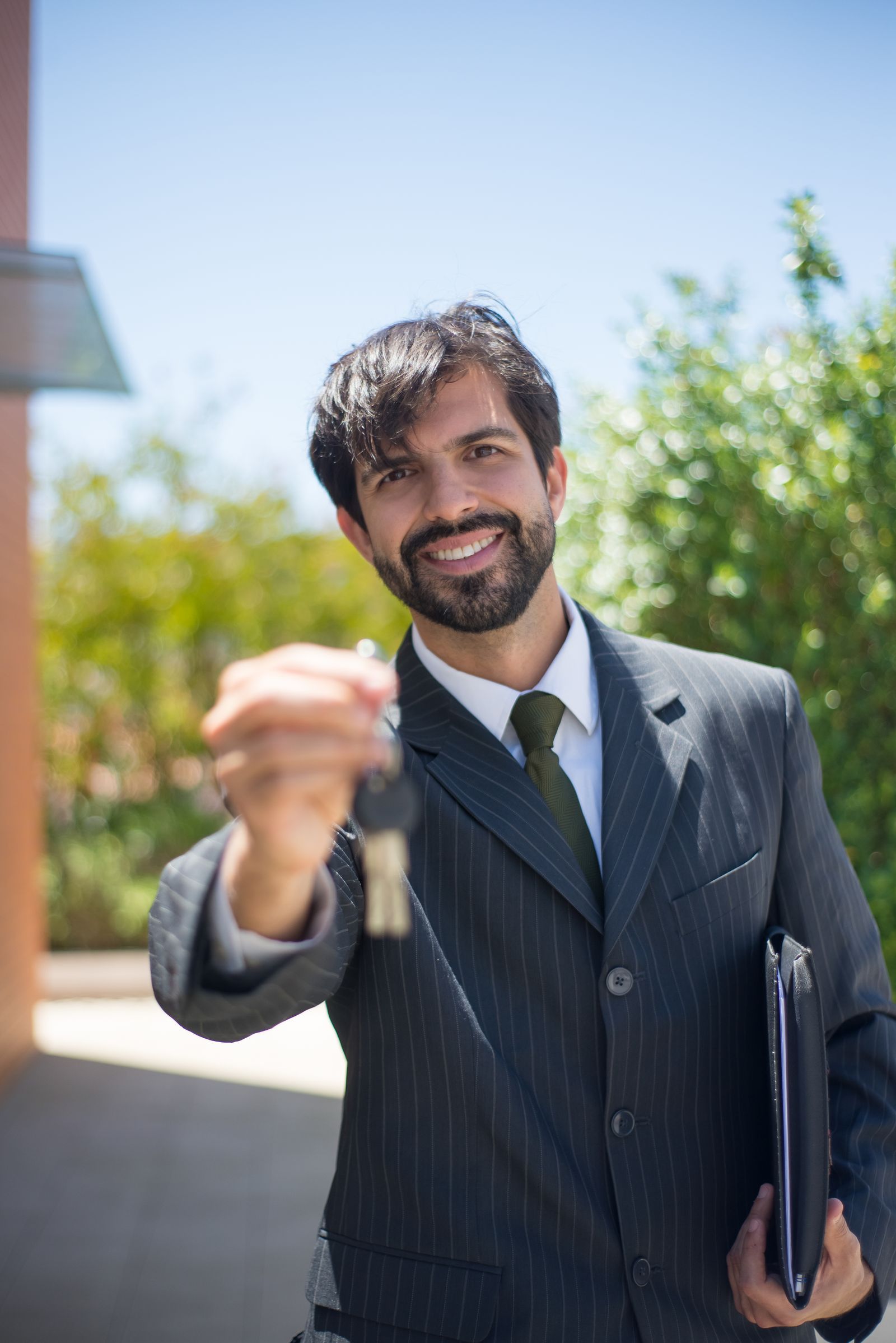 Real estate agent handing over property keys